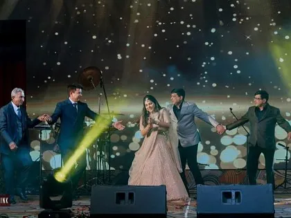 A heartwarming moment where the bride is surrounded by the men in her family during a special performance.
