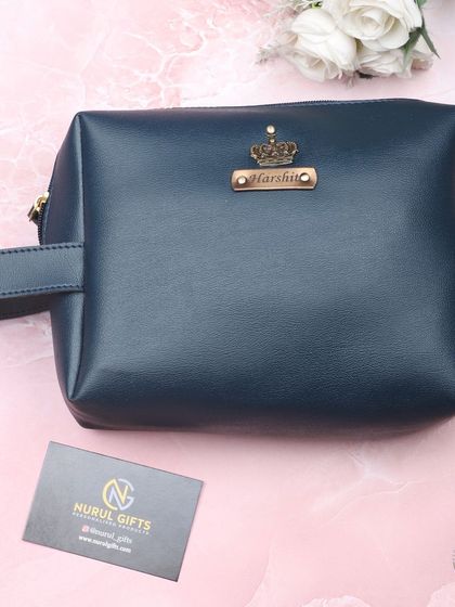 I also create personalized leather pouches, perfect for toiletries or accessories. This one is in a stylish navy blue, customized with a name and crown charm.