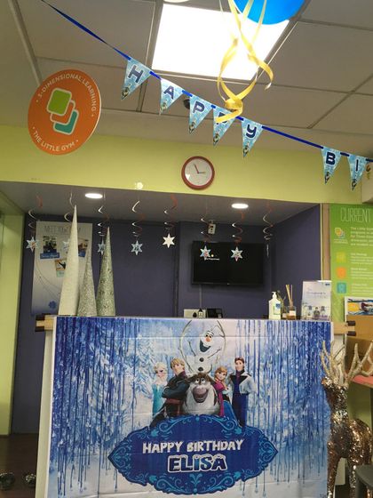 Welcome to a winter wonderland! For Elisa's birthday, we transformed our reception area with a "Frozen" theme, complete with banners and icy decorations.