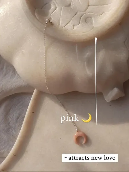 The 'etopa' pink opal moon pendant, a stone I use to attract new love. It also encourages freedom, independence, and creativity.