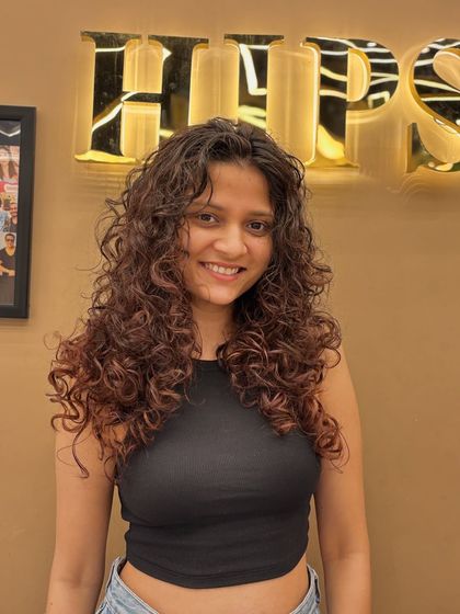 A happy client with her gorgeous, bouncy curls. This look is all about embracing natural texture and enhancing it with a great cut and style.