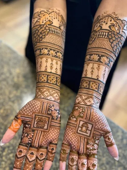 A very neat and symmetrical design with traditional symbols in square panels. This includes a kalash and a tulsi plant, bringing auspicious elements to the bridal mehndi.