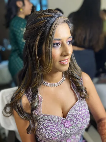 A side profile of this Sangeet look. The highlights in her hair catch the light beautifully, complementing her glowing makeup.
