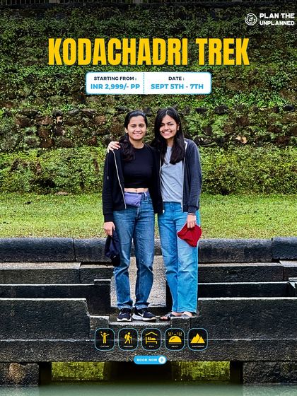 Two friends pose on an ancient stone structure during the Kodachadri trek, which is rich in both natural beauty and historical significance.