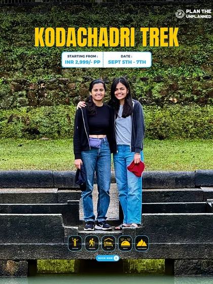 Two friends pose on an ancient stone structure during the Kodachadri trek, which is rich in both natural beauty and historical significance.