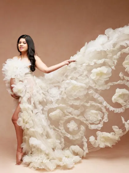 The incredible texture and volume of this floral-inspired gown are on full display as it flows in the air, creating a truly artistic shot.