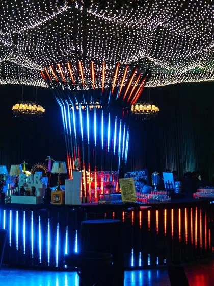 The main bar, a spectacular creation with a color-changing light installation, set under a ceiling of undulating fairy lights.
