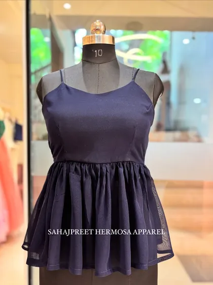The PEECHA backless kurti in a classic navy blue. This piece has a peplum silhouette with a delicate net layer.