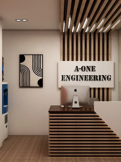 The reception area designed for 'A-ONE Engineering'. The desk features striped wood paneling, and the company's name is prominently displayed with backlighting, reinforcing brand identity from the moment a client walks in.