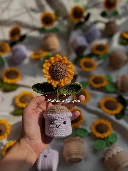 A single mini crochet sunflower pot with a cute smiling face. These little pots are designed to brighten up your desk or any small corner of your home.