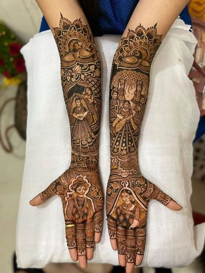A lovely design with portraits of the bride and groom on the palms, and scenes of the bride in her doli on the forearms.