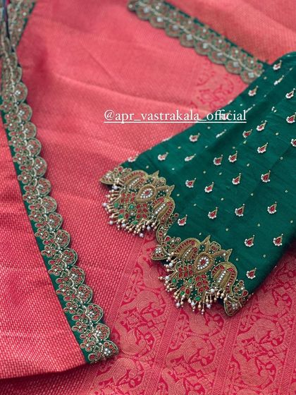 A classic combination of green and pink, this blouse has heavily worked sleeves with peacock motifs.