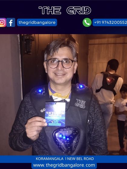 A player proudly displays his "Trigger Happy" score card after a successful laser tag match.
