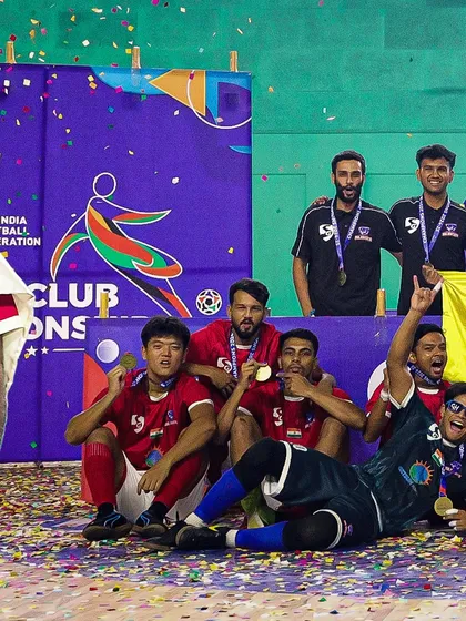 The team relaxing on the podium, soaking in the championship feeling.
