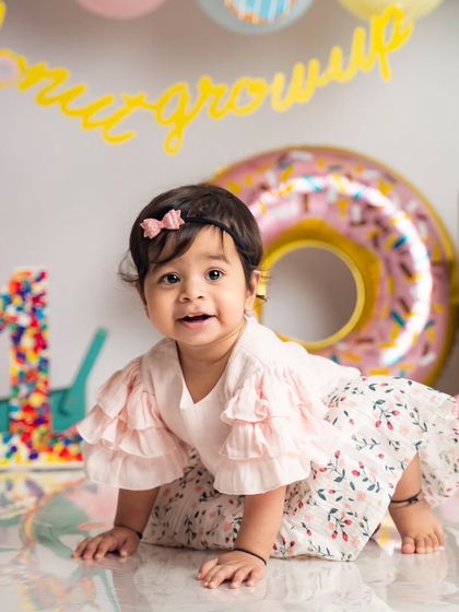 On the move. We capture babies as they are, whether they're crawling, sitting, or exploring the set during their first birthday session.