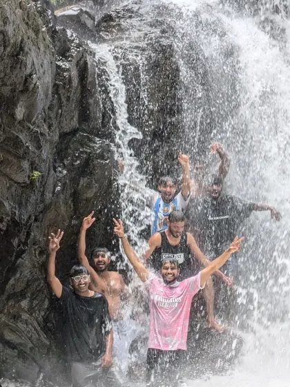 A group of guys having a great time under the Bandaje waterfalls.