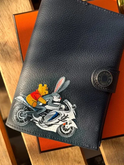 A fun and unexpected crossover. This custom wallet features Winnie the Pooh and Bugs Bunny riding a motorcycle together.