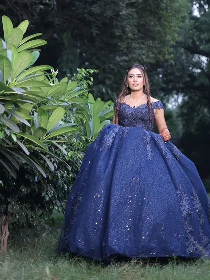 A full view of the client in her magnificent engagement gown. The makeup was kept elegant and understated to let the detailed embroidery and volume of the dress take center stage.