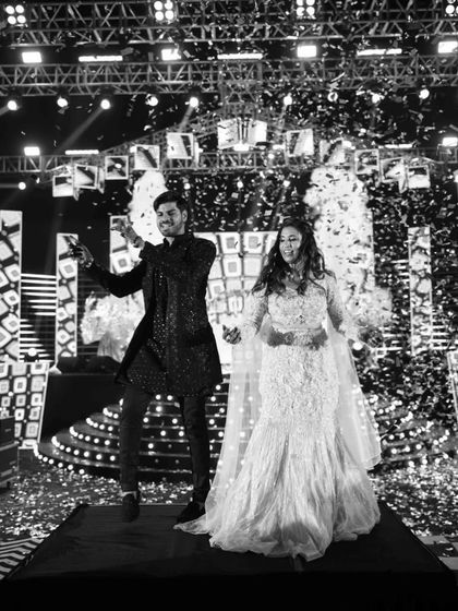 A timeless black and white shot of the couple's Sangeet performance, with confetti raining down. It captures the joy and elegance of the moment perfectly.