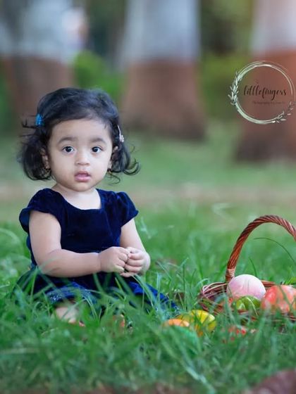 Sitting peacefully in the green grass, this little one is a picture of innocence. I love the soft, golden light of outdoor photography and how it beautifully illuminates these simple, precious moments.