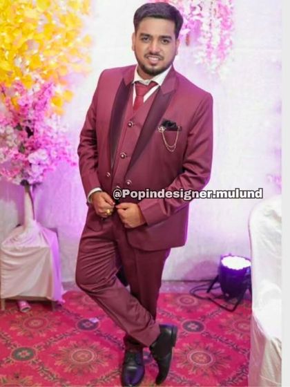 A client looking smart in a classic maroon three-piece suit. This rich color is a great alternative to black and works well for festive occasions.
