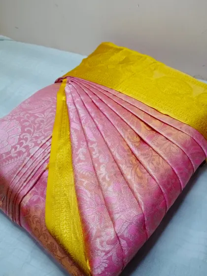 This pink and yellow silk saree is ready to be draped. You can drop off your sarees or send them via a delivery app to my Jayanagar location.