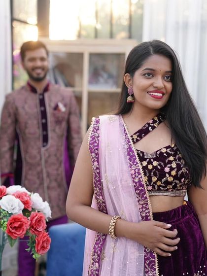 A sweet, smiling portrait of the bride-to-be, with her partner looking on. This photo captures the joy and anticipation of a pre-wedding celebration.