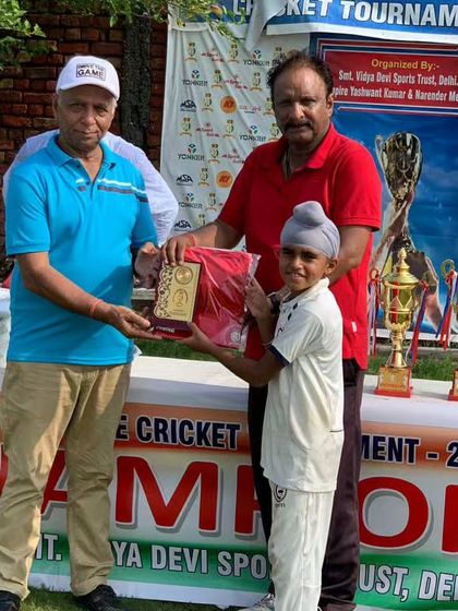 This young champion receiving his prize. We encourage players to aim for individual excellence within the team framework.