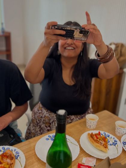 Capturing the moment. A community member films the fun during a casual get-together at our studio. We are a 'Bindaas community' that loves to create and celebrate together.