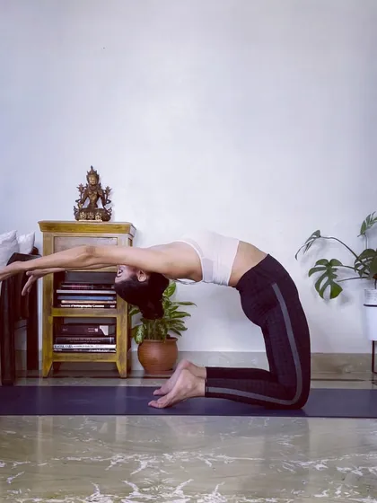 This is a variation of Camel Pose (Ustrasana), a powerful heart-opening backbend. It stretches the entire front of the body, improves posture, and builds back strength.