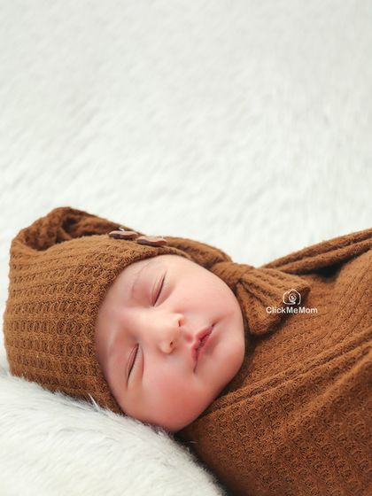 Another angle of this peaceful sleeper, showing how the soft, neutral tones of the swaddle and background keep the focus entirely on the baby.
