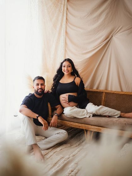 The happy couple, relaxed and smiling in our cozy boho corner. This shot perfectly captures their joy and connection.