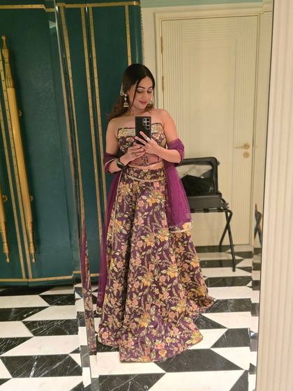 A mirror selfie showing off my corset and lehenga combination. I love experimenting with my outfits to bring that 'main character energy' to every wedding I host.