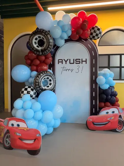 A closer look at our Cars-themed party decor. We use character cutouts and themed balloon arrangements with details like tires and checkered flags to create an immersive experience.