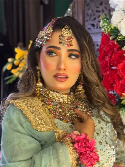 A portrait of the Haldi bride, looking radiant and ready for her ceremony. The colorful makeup is a celebration in itself.