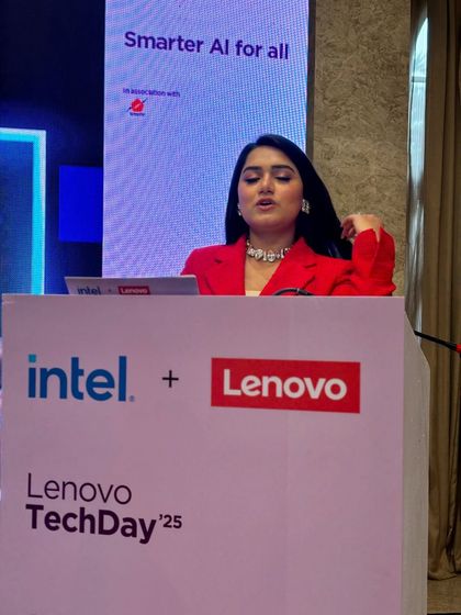 Speaking at the Lenovo TechDay, with the branding clearly visible. I always ensure the client's brand is front and center.