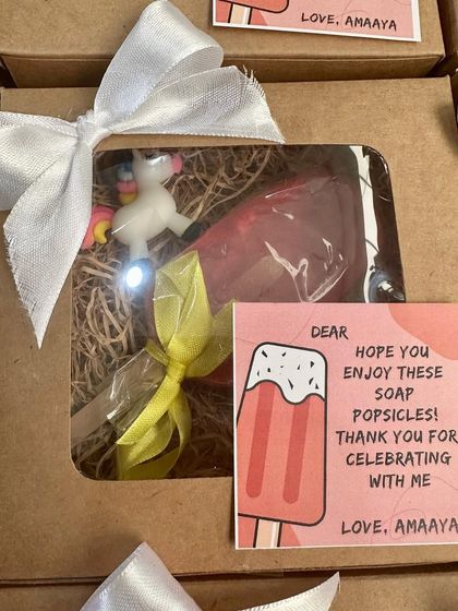 A single popsicle-themed gift box, showing the personalized card and the cute unicorn keychain included with the soap.