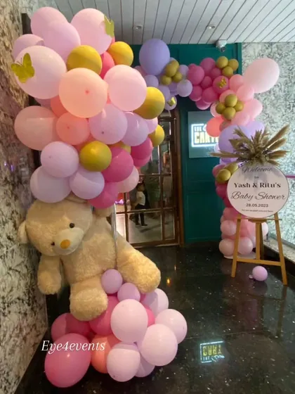 We make sure the theme begins the moment your guests arrive. This baby shower entrance features a welcoming teddy bear nestled in a beautiful pink and lilac organic balloon arch, setting a sweet tone for the party inside.