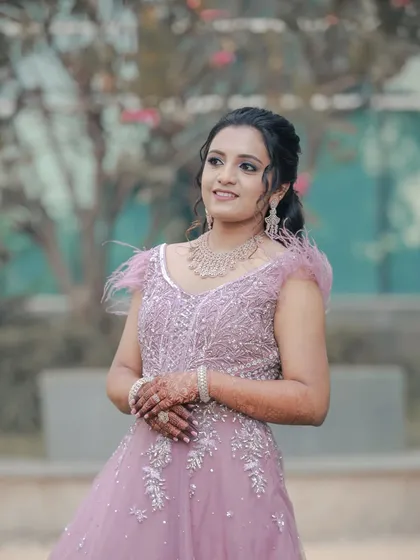 A lovely portrait of the bride in her pastel gown, captured outdoors. Her happy, natural expression is what makes this shot beautiful.