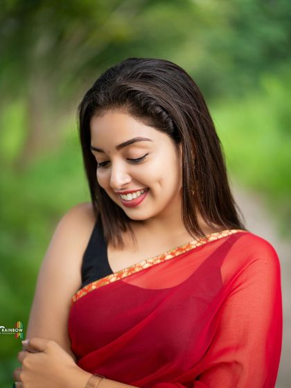 A shy, downward smile captured in a moment of candid grace. This portrait feels natural and unposed.