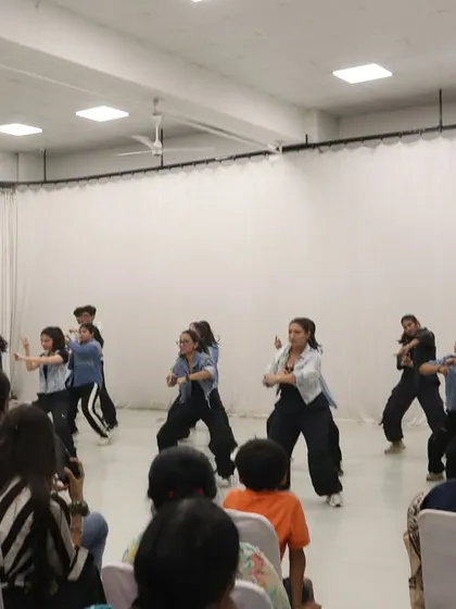 The power of a team. Students performing a dynamic hip hop choreography piece during the showcase, demonstrating the skills and confidence they built during the intensive program.