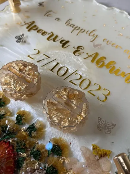 A close-up of a 3D floral look on a white resin tray. I used preserved flowers and crystals to create a beautiful, textured corner accent.