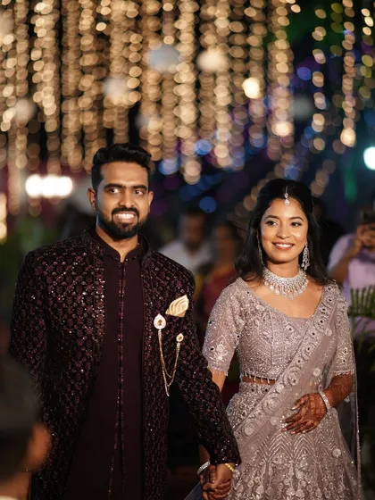 A happy moment for the couple at their reception. The bride's makeup is glamorous and festive, perfect for the celebratory atmosphere.