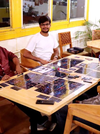 A serious game of Twilight Inscription in progress. Our spacious tables can accommodate even the most epic board games.