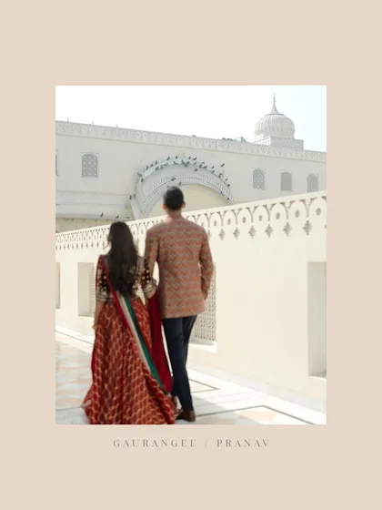 Walking away together into their future. This shot from behind, with the bride in a beautiful red lehenga, creates a sense of narrative and romance at their Jaipur pre-wedding shoot.