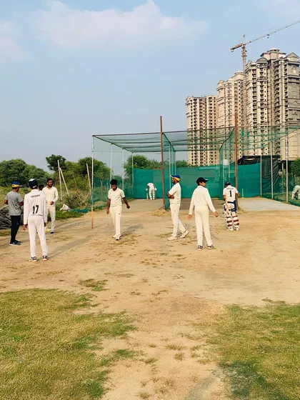 Players gather around the net area for a practice session. This is the hub of activity for teams before they take the main field for their match.