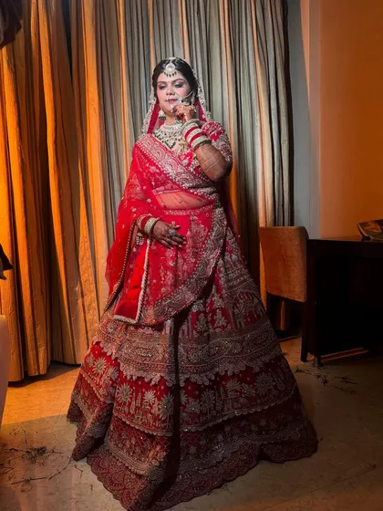 Here you can see the complete traditional bridal look. The makeup is balanced to harmonize with the heavy embroidery of the lehenga and the intricate jewelry, ensuring the bride herself remains the focus.