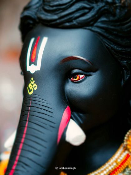 Another angle on the black Ganpati idol, capturing the intensity in its eyes. This shot is all about the emotion and power that the artisans are able to convey through their craft.