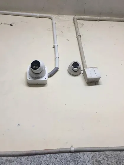 A clean installation of two dome cameras with neat wiring.