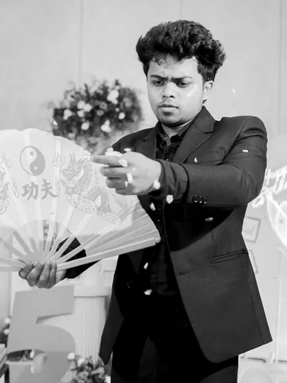 Magic is an art form. This shot captures the focus and mystery I bring to my performances, using classic props like this fan to create a moment of pure illusion and wonder.